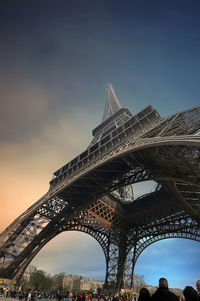 Low angle view of eiffel tower against blue sky in city