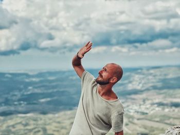 Low angle view of woman looking at sea against sky