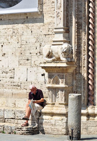 Full length of man statue outside historic building