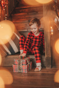 Portrait of girl playing with christmas decoration