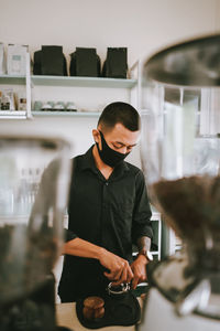 Young man working in glass