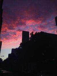 Low angle view of silhouette built structure against sky at sunset