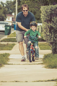 Portrait of man riding bicycle on field