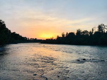 Scenic view of lake against sky during sunset