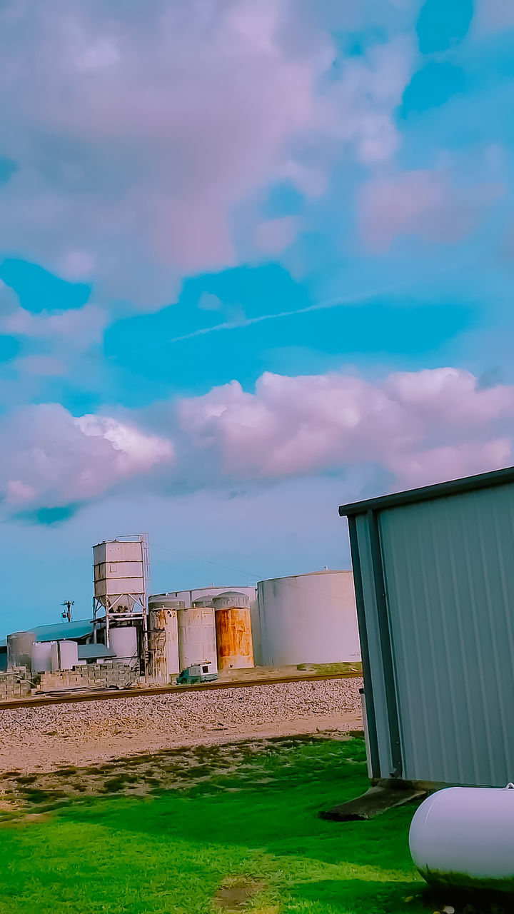 cloud - sky, sky, built structure, architecture, building exterior, no people, nature, day, green color, building, outdoors, grass, land, water, absence, low angle view, industry, field, container