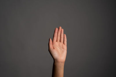 Close-up of human hand against black background