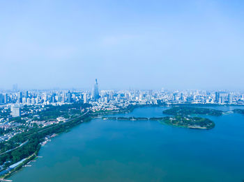 High angle view of buildings by sea against sky