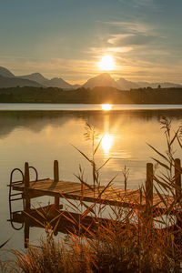 Scenic view of lake against sky during sunset