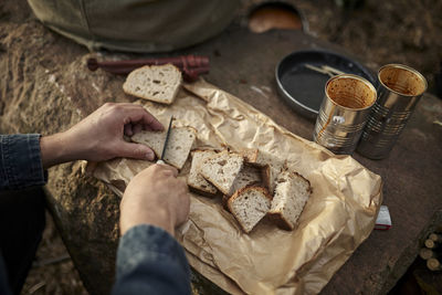 Hands cutting bread