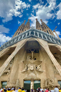 Low angle view of statues on building against sky