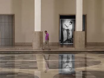 Woman walking in corridor of building
