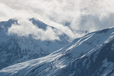 Peaks in the clouds of the grandes rousses in oisans in the alpes d'huez