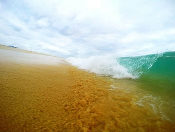 Scenic view of sea against cloudy sky