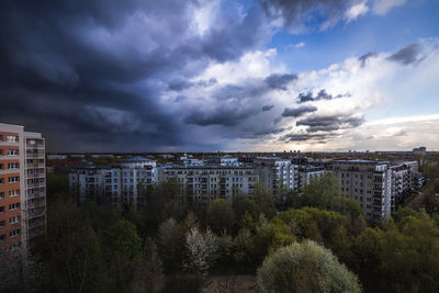 Buildings against cloudy sky