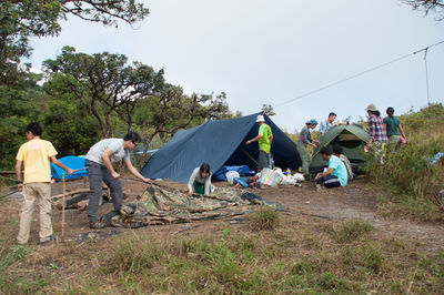 People by tents on field