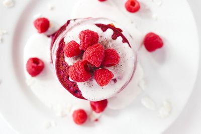 Stack of pancakes with raspberries and yoghurt