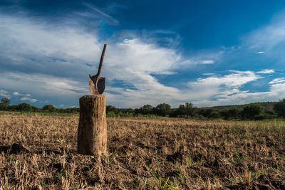 Hay bales on field against sky