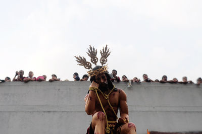 Rear view of people against sky