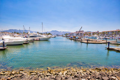 Sailboats moored in harbor