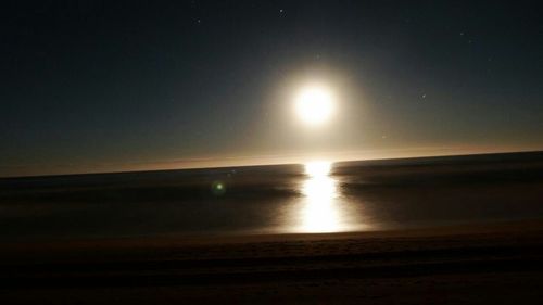 Scenic view of river at sunset