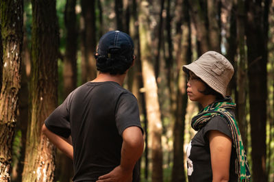 Rear view of man and woman in forest