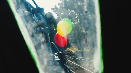 Close-up of yellow balloons on window