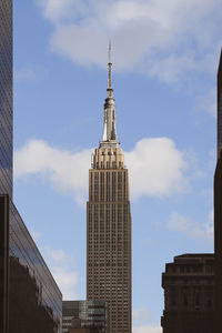 Low angle view of buildings against cloudy sky