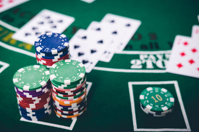 High angle view of gambling chips and cards on table