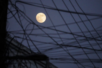 Low angle view of half moon against sky at night