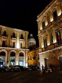 Buildings in city at night