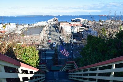 High angle view of buildings by sea against sky