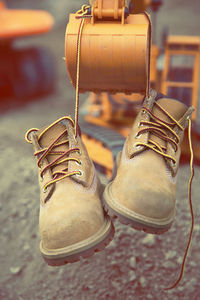 Boots hanging from toy earth mover