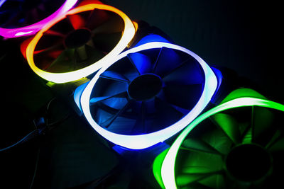 Close-up of illuminated lighting equipment against black background