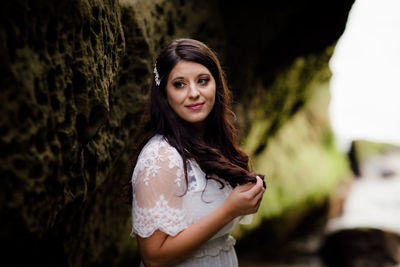 Portrait of a smiling young woman standing outdoors