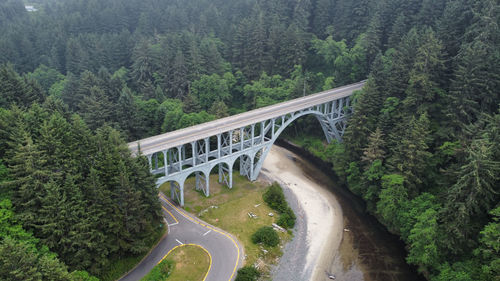 High angle view of bridge over road in forest