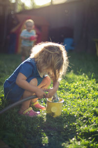 Full length of girl holding grass