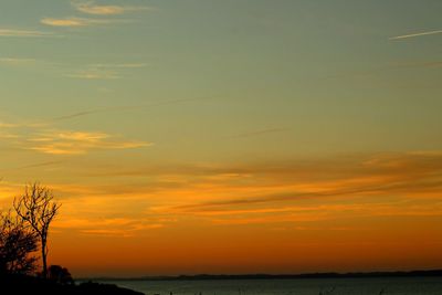 Scenic view of sea against romantic sky at sunset