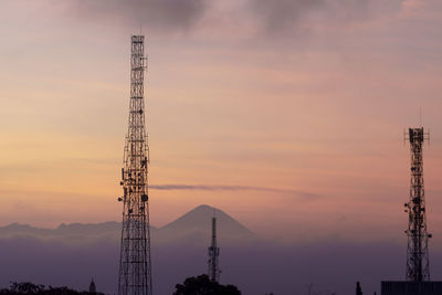 Low angle view of crane against sky during sunset