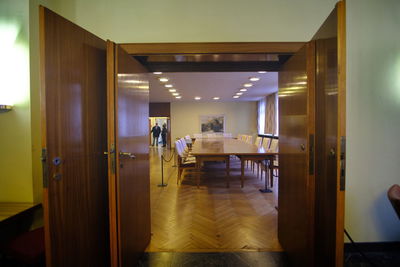 Empty chairs and tables in illuminated building