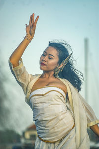 Balinese dancer while dancing in a ceremony