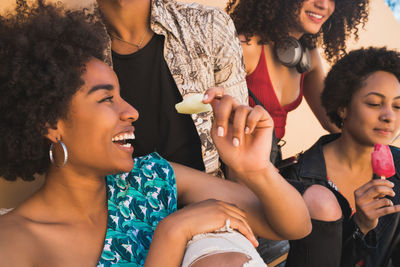Young woman sitting in the group of people