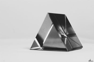 Close-up of umbrella on table against white background