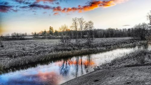 Scenic view of lake against sky during winter