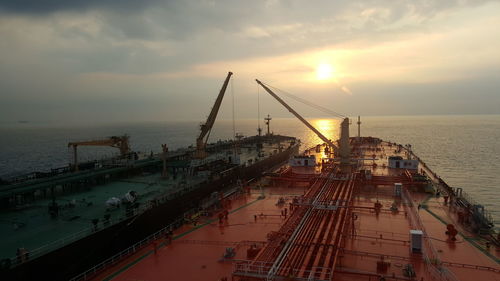 Panoramic view of pier over sea against sky during sunset