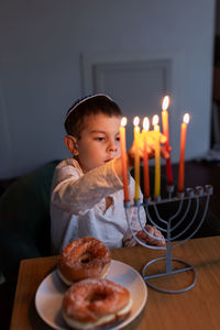 Close-up of illuminated candles on table