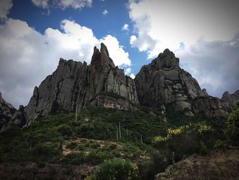 Scenic view of mountains against cloudy sky