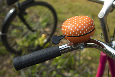 Close-up of bicycle parked against blurred background