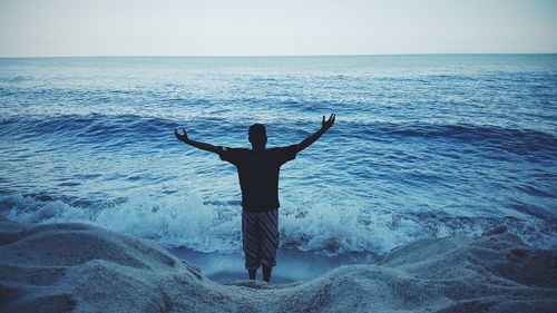 Silhouette of woman standing on beach