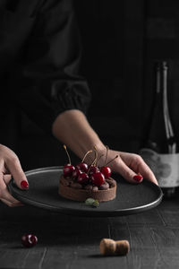 Chocolate tart with ganache decorated with fresh cherry