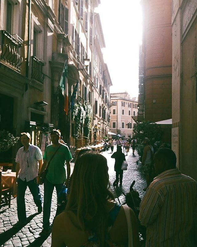 building exterior, architecture, built structure, men, lifestyles, person, city, leisure activity, rear view, street, city life, large group of people, walking, building, residential building, medium group of people, residential structure, sunlight, clear sky